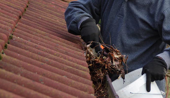 removing debris and twigs from gutters